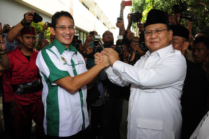 Ketua Dewan Pembina DPP Asosiasi Pedagang Pasar Seluruh Indonesia (APPSI) Prabowo Subianto (kanan) berjabat tangan dengan Ketua Umum APPSI yang baru Sandiaga Uno (tengah) sebelum pelantikan ketua dan pengurus di Gor Pasar Senen Jakarta, Selasa (22/3).
